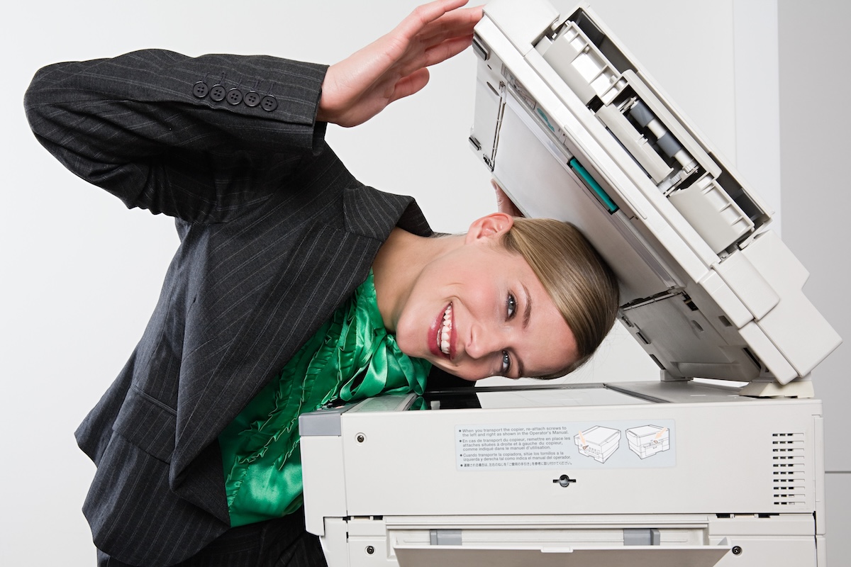 “Woman photocopying her face” licensed via iStock